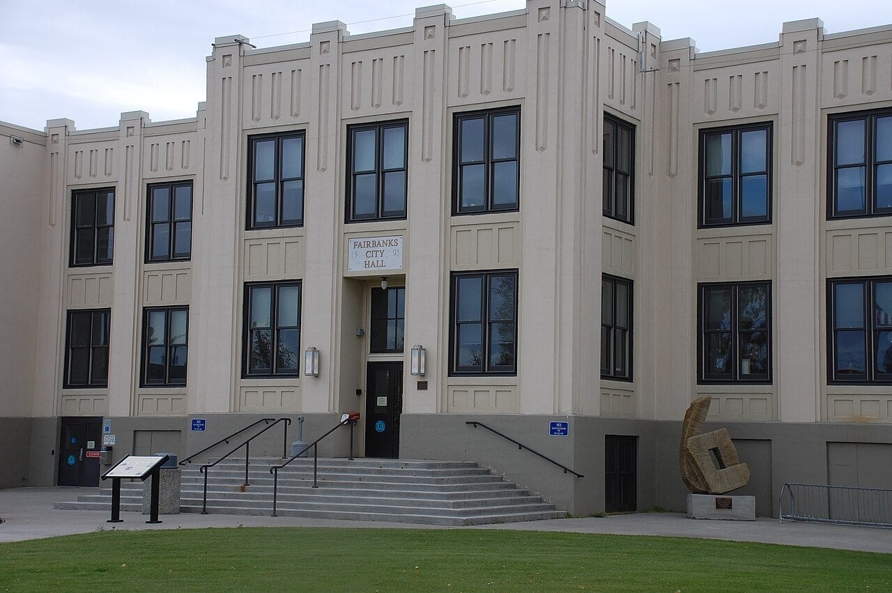 City Hall building featuring classic architecture, large windows, and accessible ramps in an urban s.